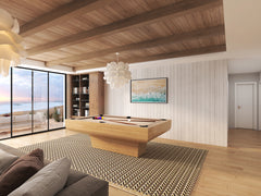 Modern billiard table in custom oak finish with windows overlooking a scenic ocean view.